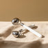 SteelChill Stainless Ice Roller on warm beige linen in a sunlit minimalist room