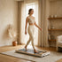 Person walking on the StrideDesk Walker in a sunlit minimalist beige room