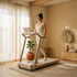 Person using the SteadyStep Treadmill in a sunlit minimalist beige room