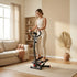 Person using the SwivelFit Stepper in a sunlit minimalist beige room
